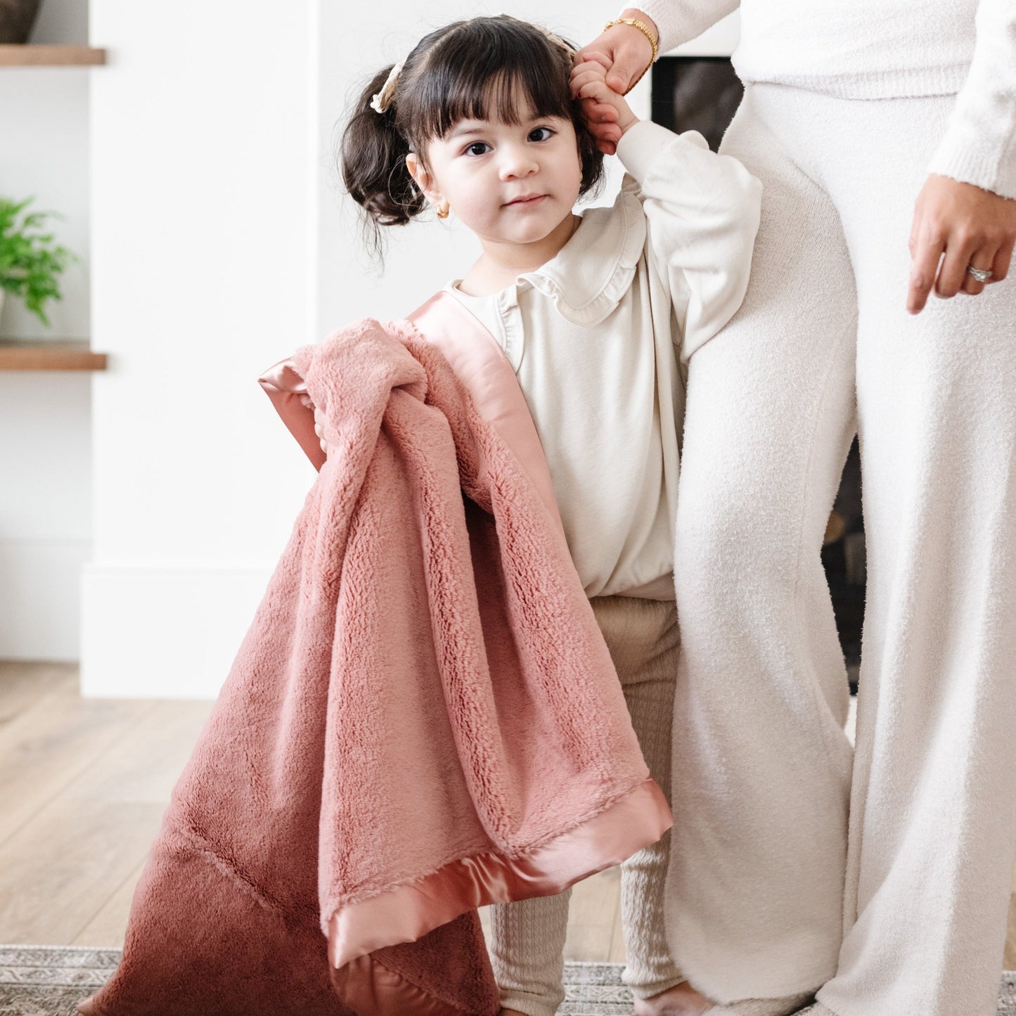 Little girl holding a gorgeous salmon receiving blanket.