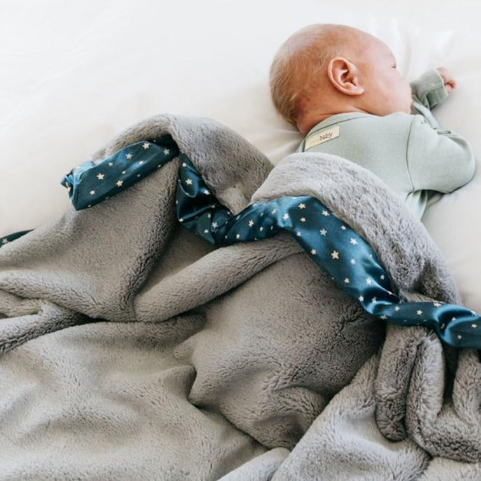 Snuggly receiving blanket with a soft, gentle texture, perfect for wrapping your baby in warmth.
