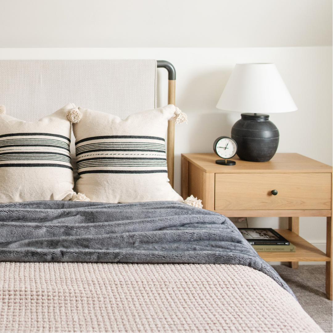 On a bed is a Saranoni Grand Faux Fur blanket, featuring an elegant light charcoal tone and luxuriously soft texture. This cozy, queen-sized blanket and faux fur blanket offers soothing weight, premium softness, timeless comfort, and is a soft blanket. Perfect as a big blanket and luxury blanket for snuggling or as a luxury bedroom accent, this Saranoni blanket elevates every cozy moment and is a cozy blanket.