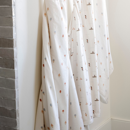 Three Saranoni hooded towels. These luxury hooded towels are perfect for bath time, pool days, and beach outings, being gentle on sensitive skin. Designed as toddler hooded towels, these bath towels provides a cozy, plush feel that keep little ones warm after water play. Ideal for parents looking for the best soft toddler towel that combines style, durability, and ultimate comfort. These kid's towels have an ice cream print or a print with people. These are hooded towels for toddlers. 
