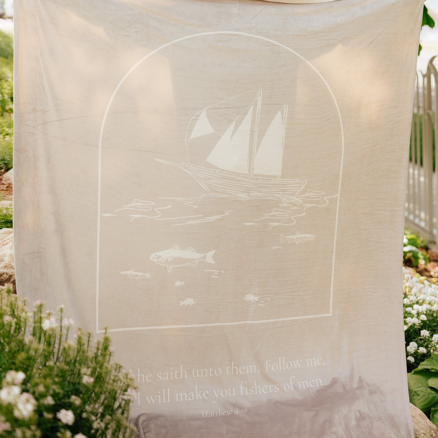 Fishers of Men Christian blanket with Matthew 4:19 Bible verse and sailboat design displayed outdoors, a meaningful Christian gift