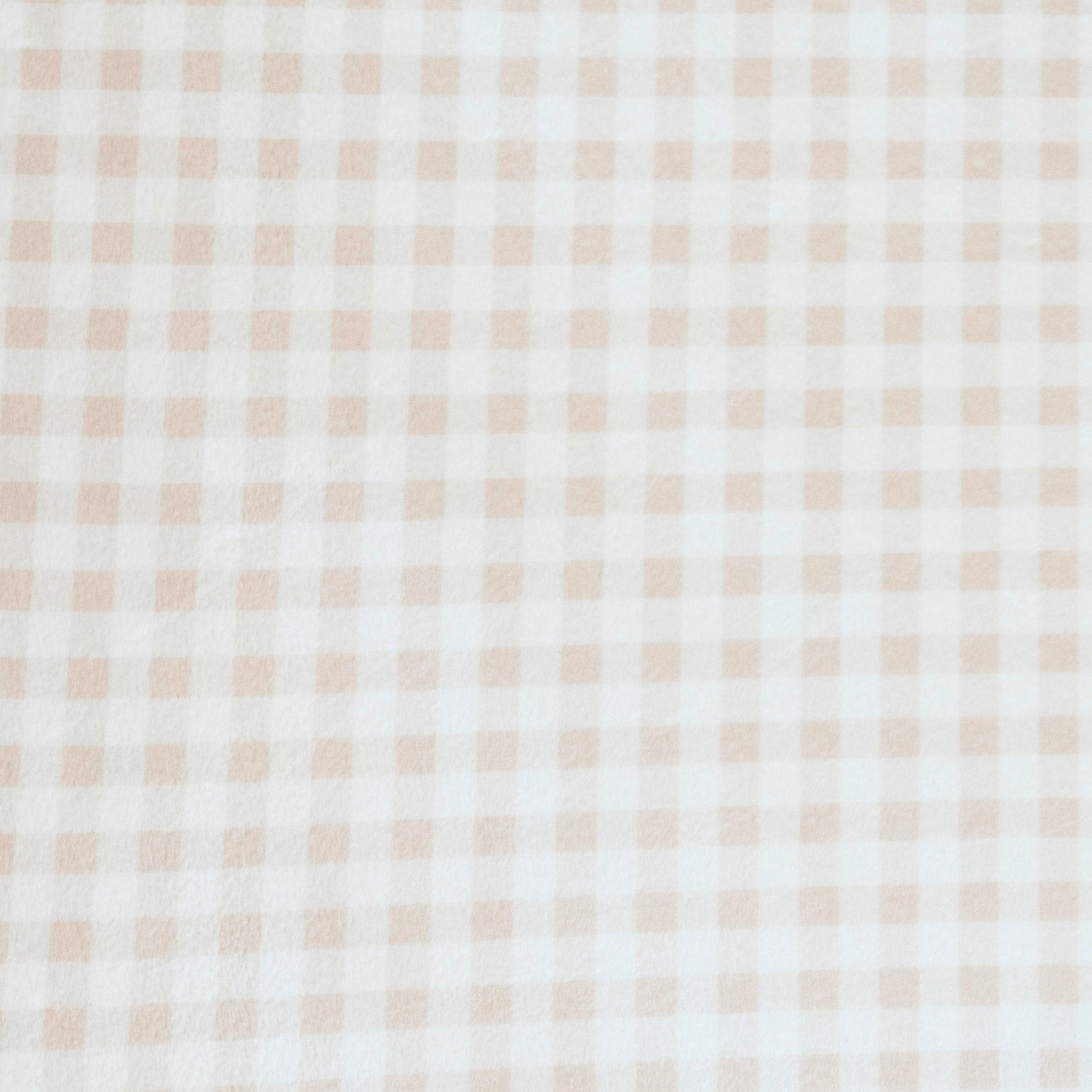 Close-up of Minky Stretch Luxe fabric in a delicate gingham pattern. Made from 94% polyester and 6% spandex, this ultra-soft, stretchy fabric is perfect for baby essentials like swaddles, changing pad covers, and crib sheets.