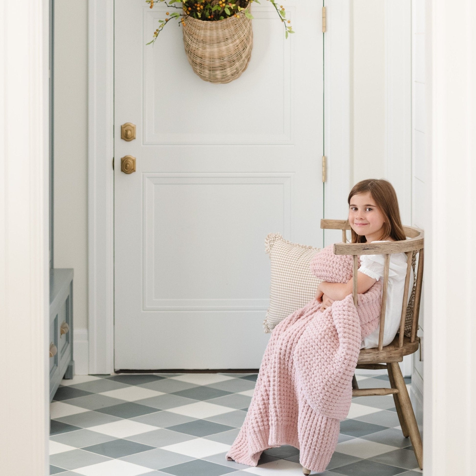 Little girl snuggling with cozy Rosette Waffle Knit Toddler blanket